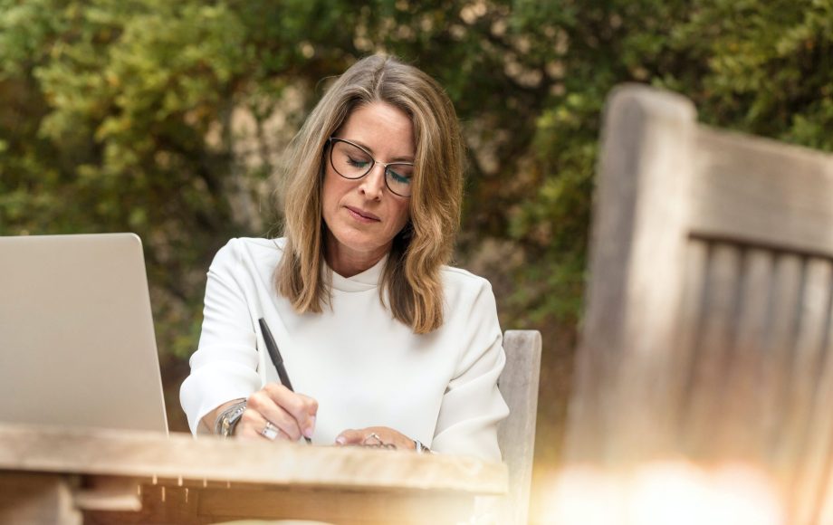 Older woman writing on paper