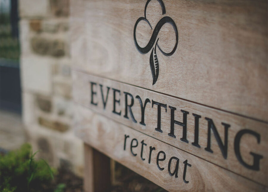 close up of wooden sign for everything retreat