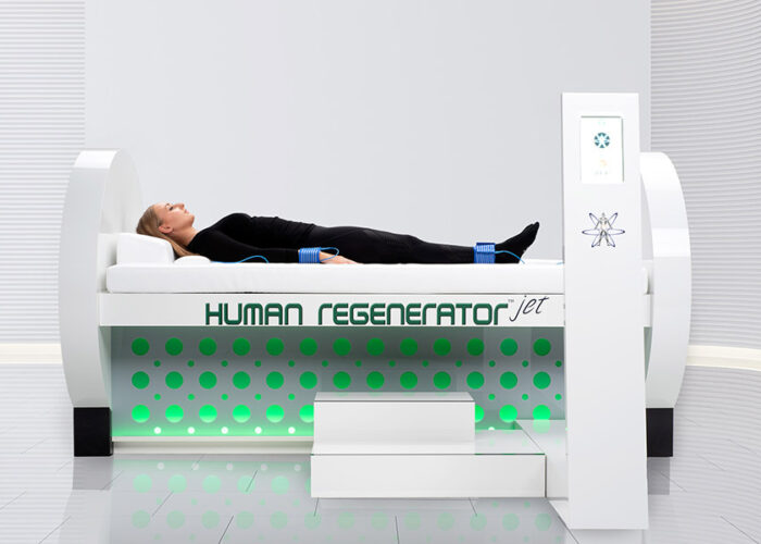 woman lying on human regenerator machine in white room