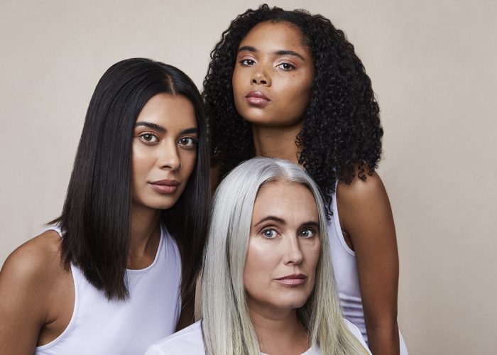 three woman with different hair types looking at the camera
