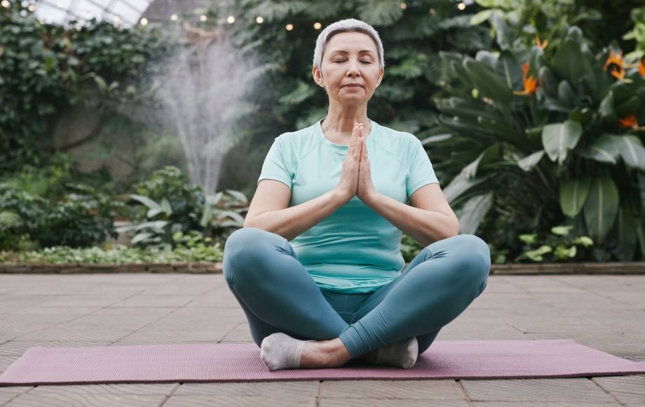 Senior woman holding lotus position