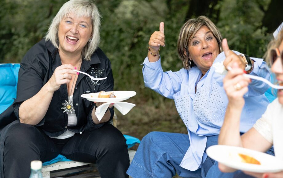 Joyful-mature-women-enjoying-food-and-friendship-at-a-picnic